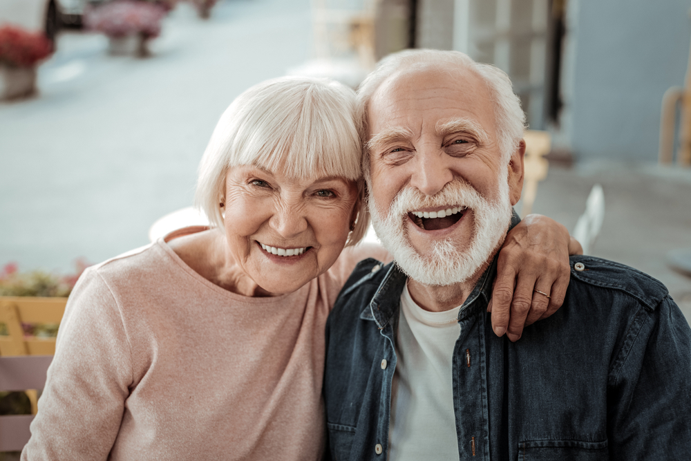 A joyful elderly couple smiling, benefiting from services like Partial Dentures at Spencer Dental in Maryville