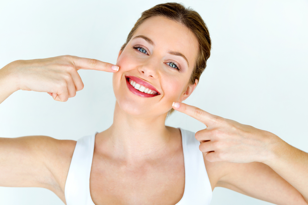 Portrait of a beautiful young woman with a perfect smile, showcasing Cosmetic Dentistry at Spencer Dental in Maryville